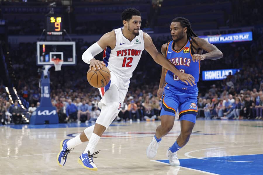 Apr 2, 2025; Oklahoma City, Oklahoma, USA; Detroit Pistons forward Tobias Harris (12) drives around Oklahoma City Thunder guard Cason Wallace (22) during the second quarter at Paycom Center. Mandatory Credit: Alonzo Adams-Imagn Images
